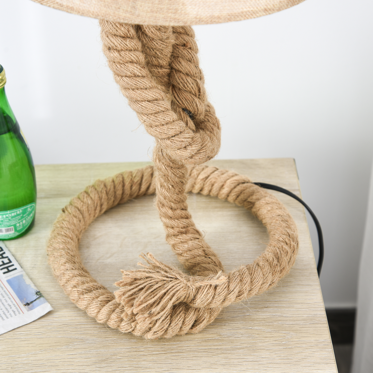 A detailed view of the base of the Aldeburgh table lamp, focusing on the hemp rope wrapping and linen shade for a tactile fee