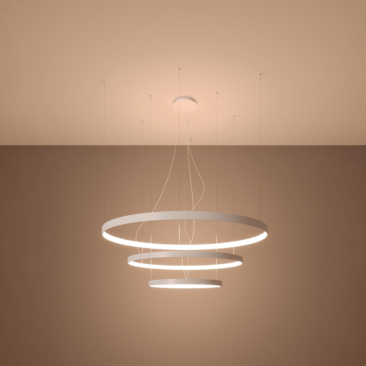 Side view of the Rio tiered LED halo pendant chandelier in a stylish living room setting, demonstrating its elegant presence