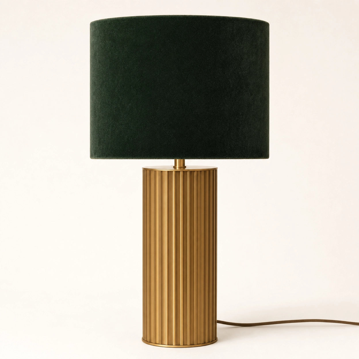 Albany fluted brass touch table lamp on a soft warm-white background — full product view of the brushed brass column with vertical fluting beneath a deep forest-green velvet drum shade