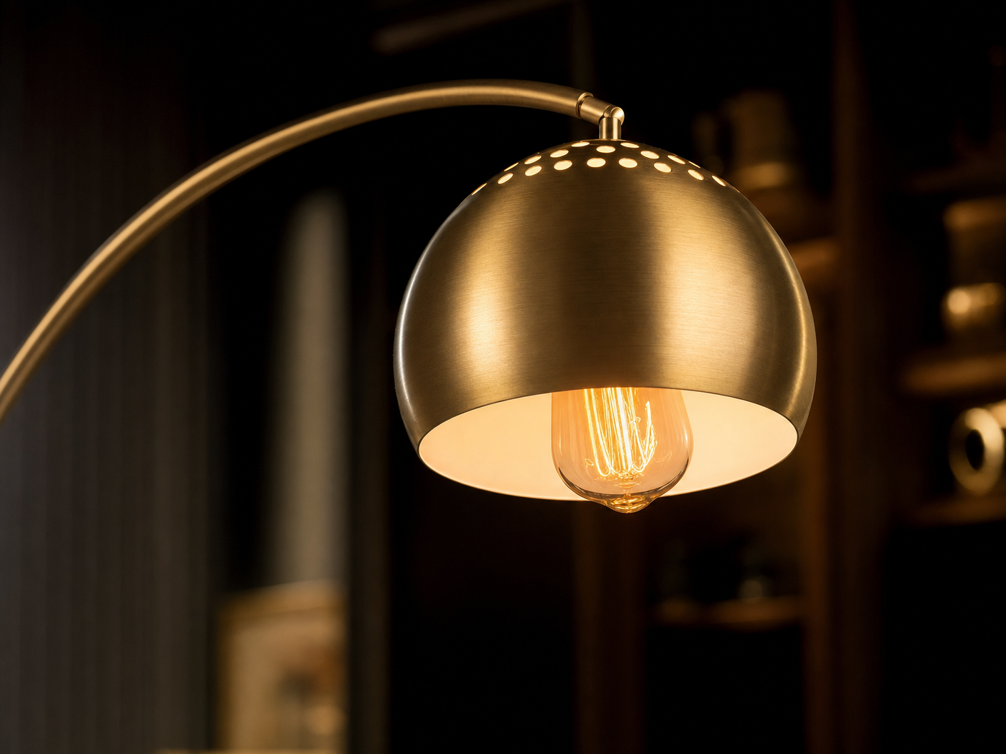Close-up of the Mayfair brushed gold perforated dome shade with Edison filament bulb