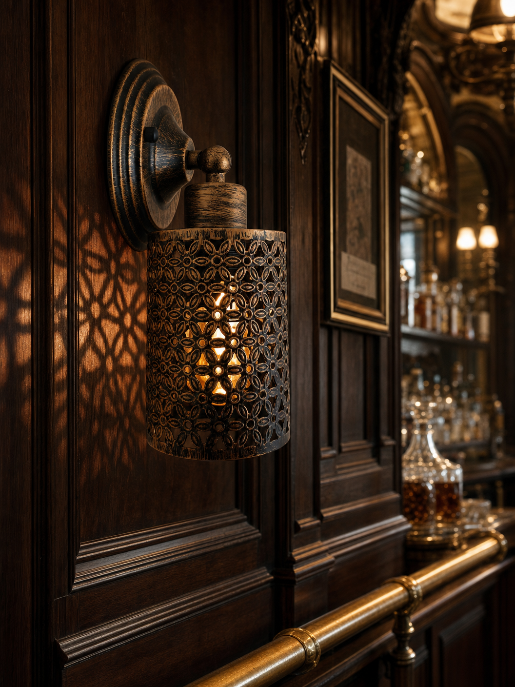 Spitalfields perforated copper wall sconce on dark wood panelling in a Victorian-style bar casting intricate shadow patterns